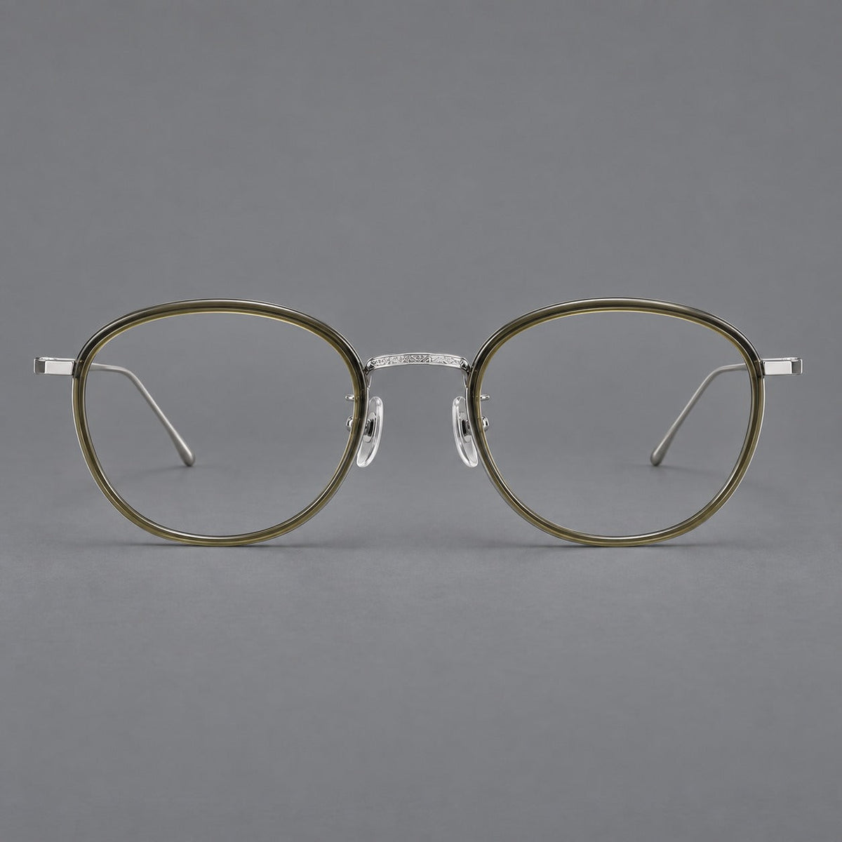 Montatura rotonda vintage in acetato e titanio con ponte inciso e aste sottili — immagine del prodotto