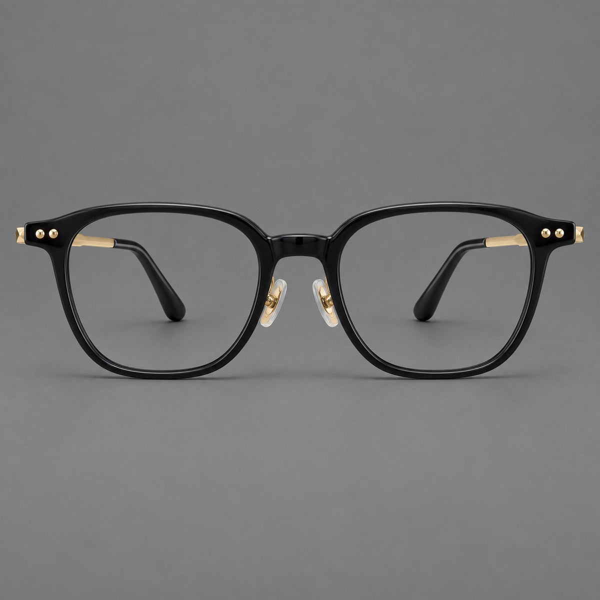 Montatura vintage in acetato e titanio con bordi quadrati arrotondati e aste traforate — immagine del prodotto