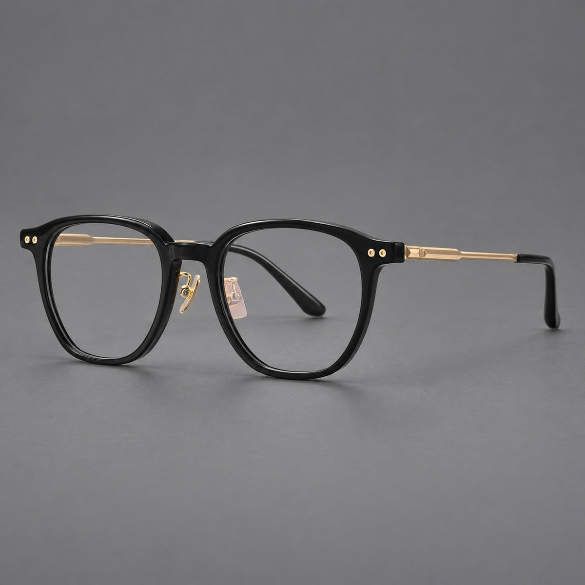 Montatura vintage in acetato e titanio con bordi quadrati arrotondati e aste traforate — immagine del prodotto