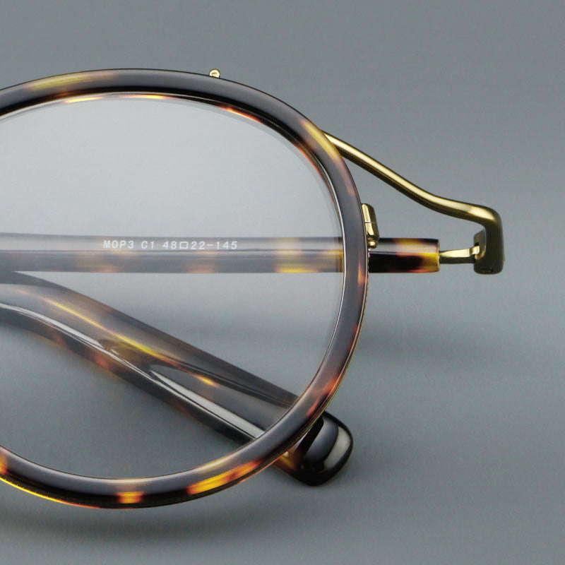 Montatura rotonda rétro in acetato con ponte sottile in metallo e dettagli laterali — dettaglio 23