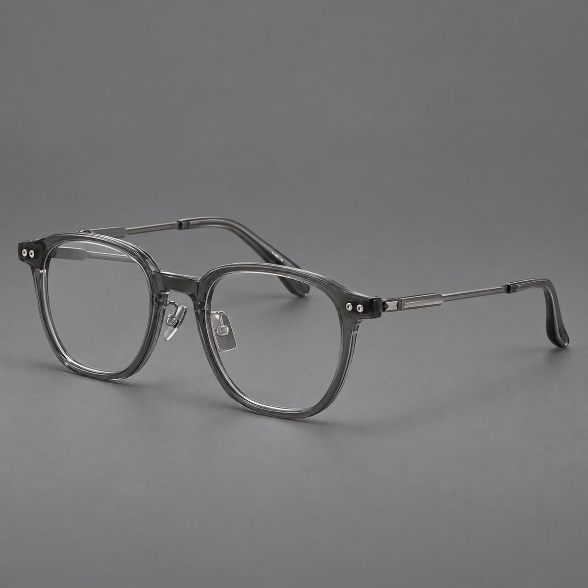 Montatura vintage in acetato e titanio con bordi quadrati arrotondati e aste traforate — immagine del prodotto