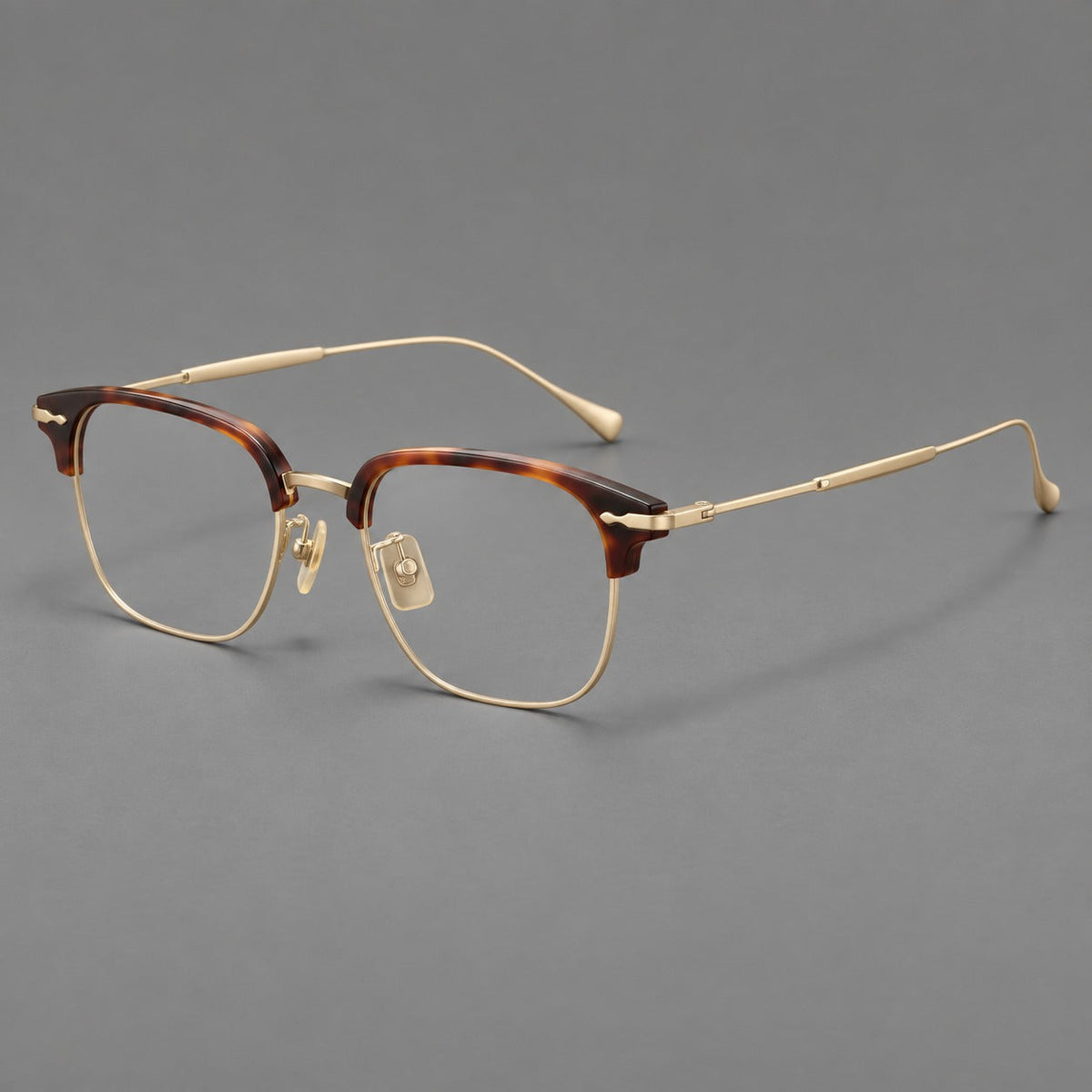 Montatura browline in acetato e titanio con bordi inferiori sottili e angoli decorati — immagine del prodotto