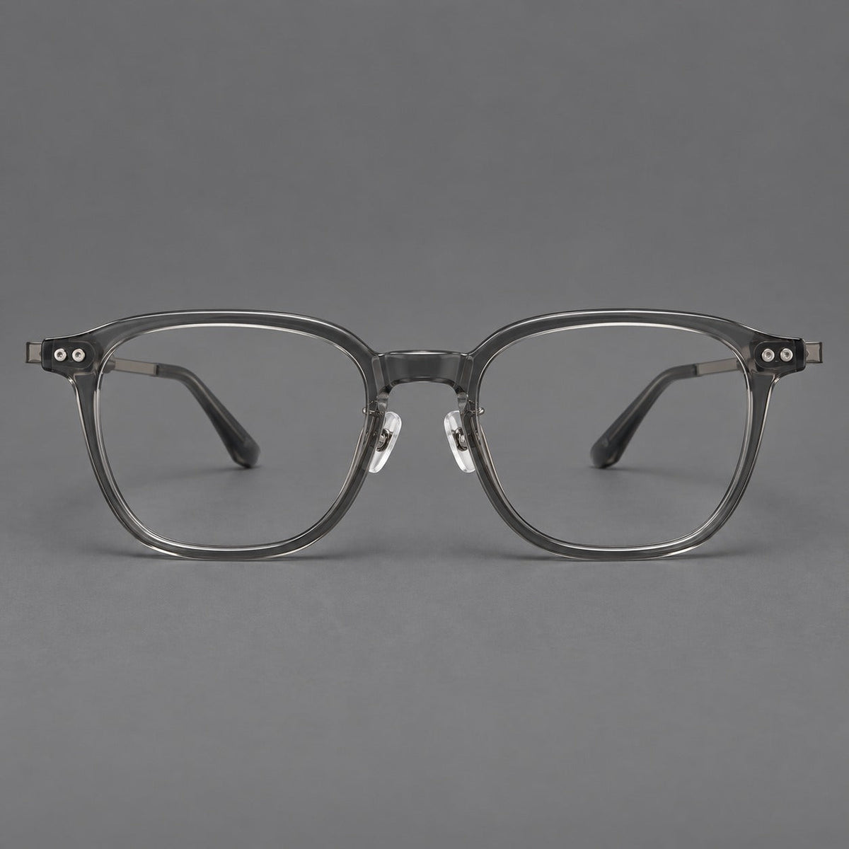 Montatura vintage in acetato e titanio con bordi quadrati arrotondati e aste traforate — immagine del prodotto