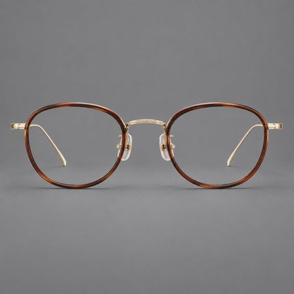 Montatura rotonda vintage in acetato e titanio con ponte inciso e aste sottili — immagine del prodotto