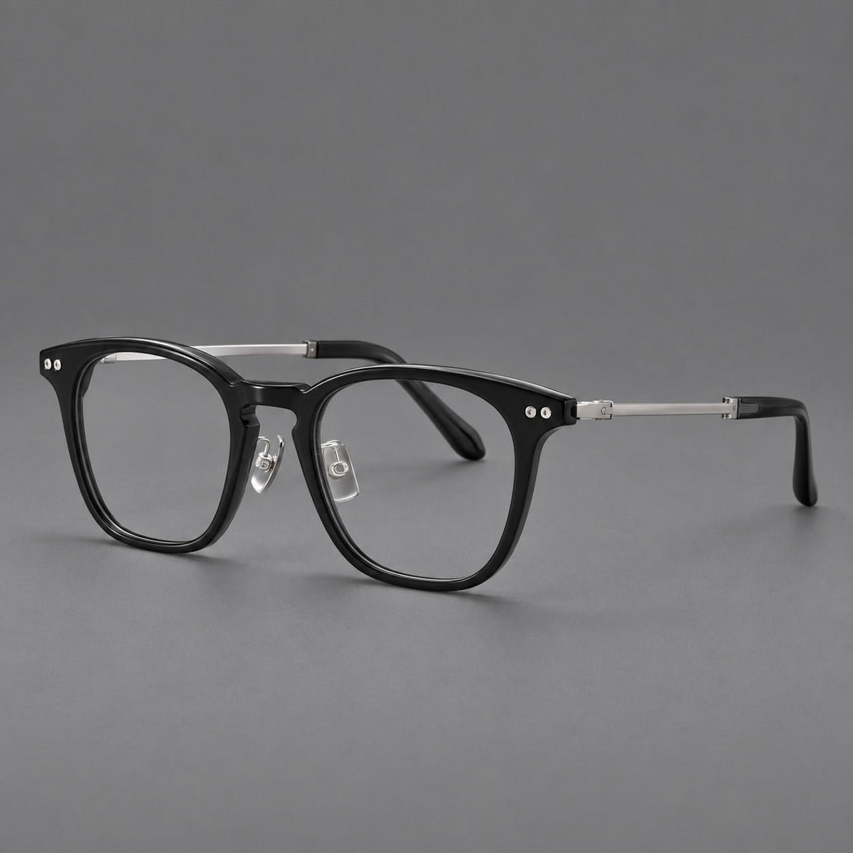Montatura rétro in acetato e titanio con linee quadrate morbide e cerniere circolari — immagine del prodotto
