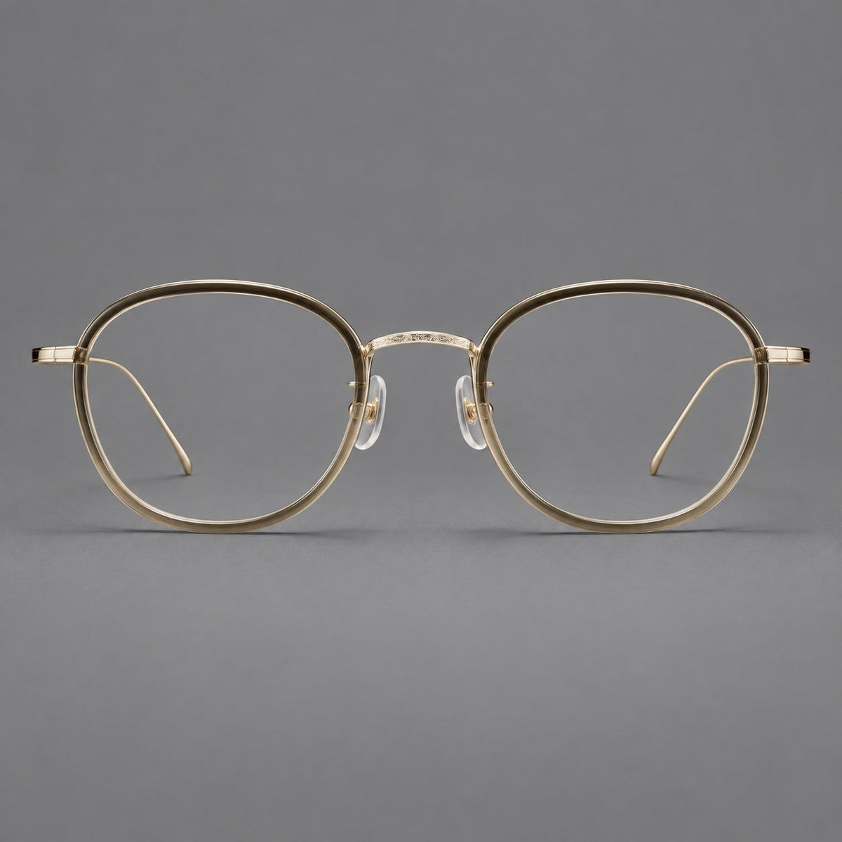 Montatura rotonda vintage in acetato e titanio con ponte inciso e aste sottili — immagine del prodotto