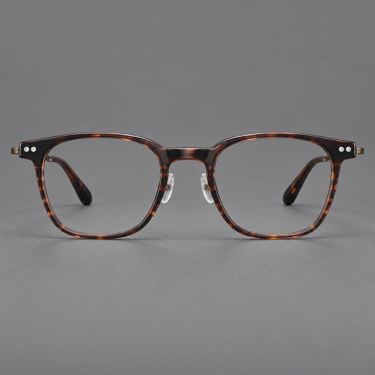 Montatura vintage in acetato e titanio con linee quadrate morbide e rivetti doppi — immagine del prodotto
