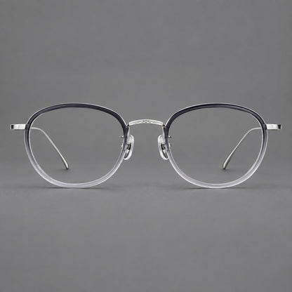 Montatura rotonda vintage in acetato e titanio con ponte inciso e aste sottili — immagine del prodotto